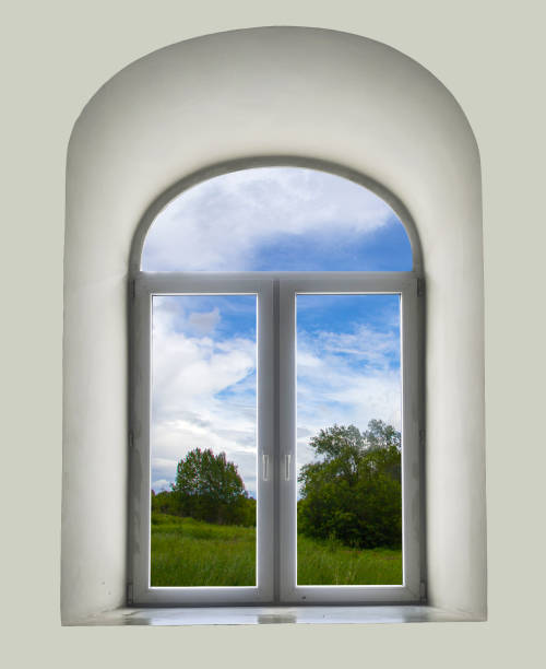 istock white semicircular modernist windows on a white wall summer, sky, clouds, trees, grass, meadow in the window 649270820