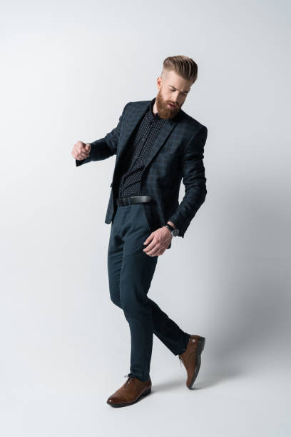 istock stylish bearded man in suit on white 649271004