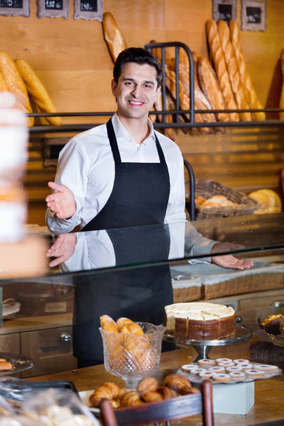 istock Friendly smiling cafe staff offering fancy and cakes 649277630