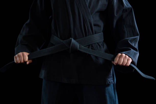 istock Mid section of confident karate player holding his belt 649282494