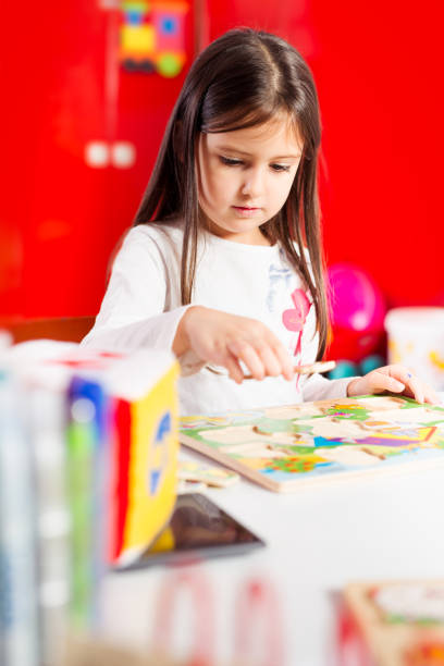 istock Little girl drawing on her book and having fun at play table 649286052