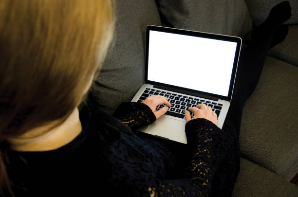 istock Woman working on laptop with blank illuminated screen and copy space 649290490