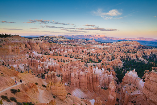 Classic view of Bryce Canyon National Park in beautiful golden evening light at sunset with blue sky and dramatic clouds seen from famous Sunset Point in summer, Utah, American Southwest, USA