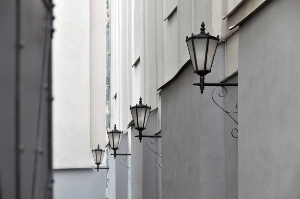 istock Narrow alley with old wall lanterns in perspective. 649298752