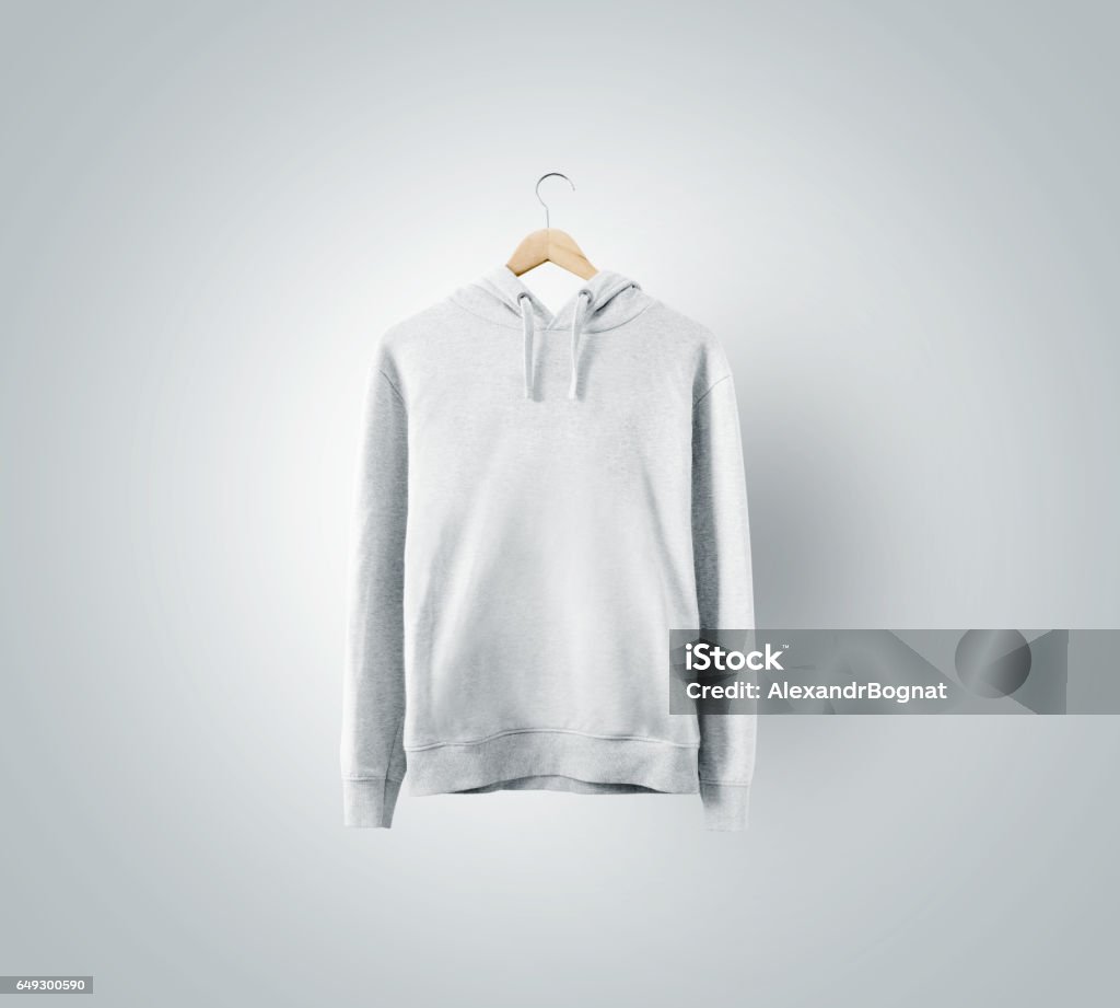 Blank white sweatchirt mockup hanging on wooden hanger Blank white sweatchirt mockup hanging on wooden hanger. Empty sweat shirt mock up on rack isolated. Clear cotton hoody template. Plain textile hoodie design presentation. Loose overall casual jumper. Hooded Shirt Stock Photo