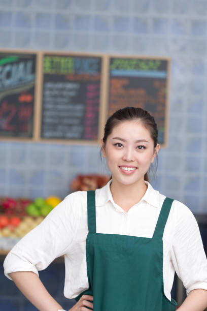 istock young pretty woman works in fruit store 649301660
