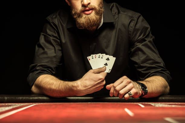 cropped shot of bearded man showing poker cards - snooker table imagens e fotografias de stock