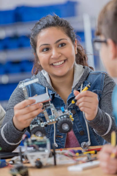 istock Cheerful Indian high school student builds robot 649303216