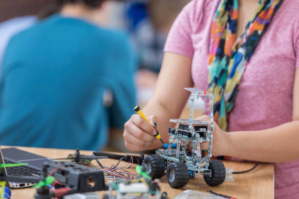 istock Unrecognizable high school student builds robotic vehicle 649303252