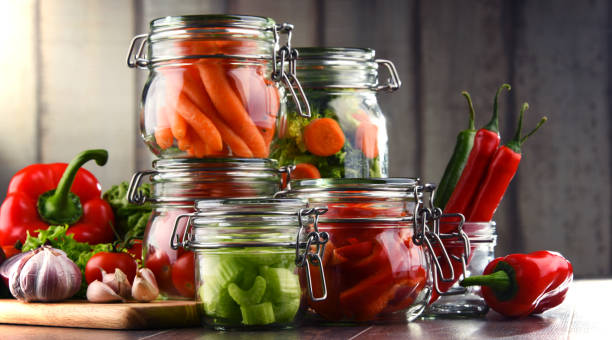 istock Jars with marinated food and raw vegetables on cutting board 649303728