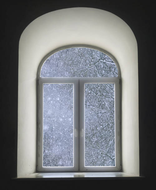 istock white semicircular modernist windows on a black wallwinter, snow, snowstorm, snowfall in the window 649303810
