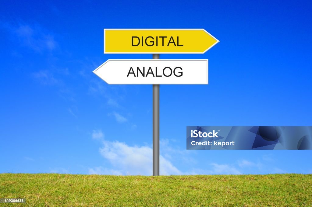 Signpost showing Analogue and Digital german Signpost outside is showing Analogue and Digital in german language Analog Stock Photo