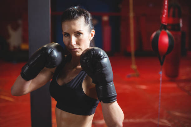 istock Confident female boxer performing boxing stance 649312354