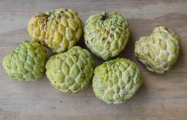 istock custard apple on wooden board 649314400