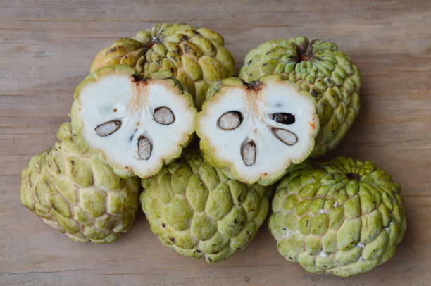 istock sugar apple cut on wooden board 649315084