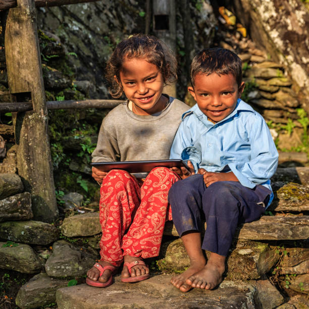 istock Nepalese children using digital tablet near Annapurna Range 649330696