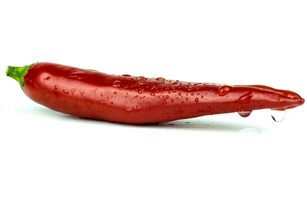 Closeup of a red chili pepper om white,  with moisture and water drops. Hot and spicy