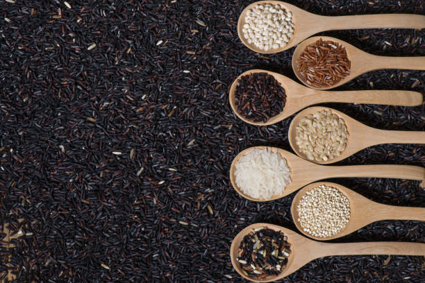 istock Different rice in wooden spoon witn Rice berries background 649331764