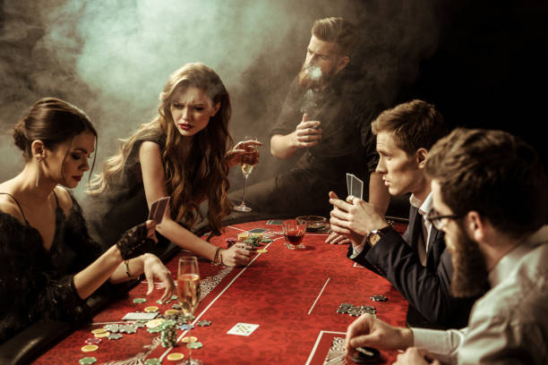 side view of people playing poker together in casino side view of people playing poker together in casino smoking women luxury cigar stock pictures, royalty-free photos & images