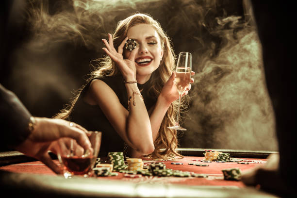 portrait of smiling woman with drink and poker chip portrait of smiling woman with drink and poker chip playing poker casino photos stock pictures, royalty-free photos & images