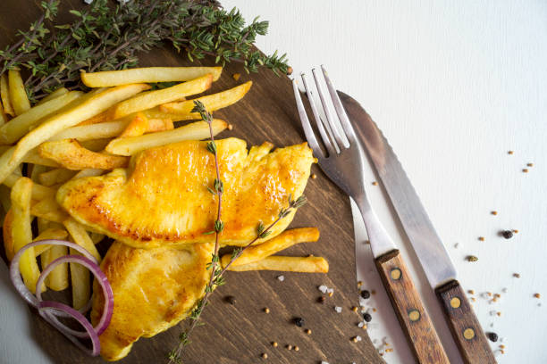 istock Turkey steak on a wooden Board. on white background 649345696