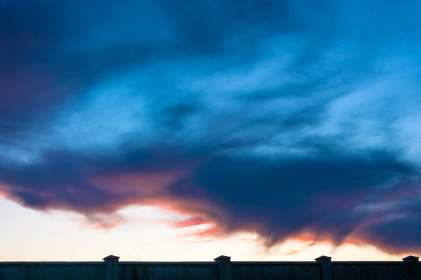 Dark blue sky with a red border on stone wall background.