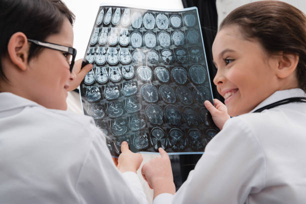 istock Smiling kids doctors holding x-ray image 649350894
