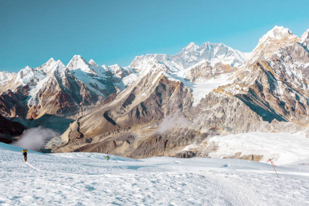 istock Snow and Mountains View and small Body of Climber walking 649355172