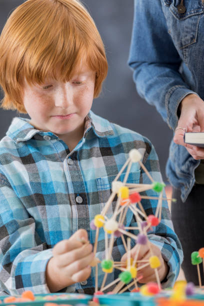 istock Cute elementary school student builds something in engineering club 649355718