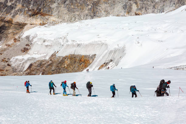 istock Mountain Climbers walking on snowy Glacier among high Peaks 649356032