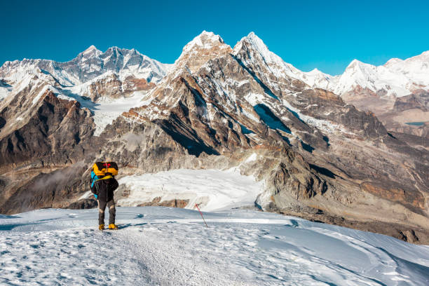 istock Mountain Climber ascending high Altitude Peak walking on Snow terrain 649356260
