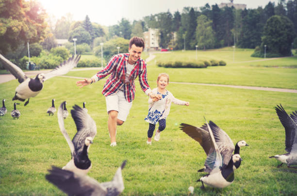 Father and daughter having fun in summer day.