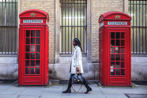 Outdoor walks, one young black woman walking in Central London for shopping