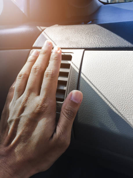 istock Hand on air conditioner vents car with sunlight. 649360884
