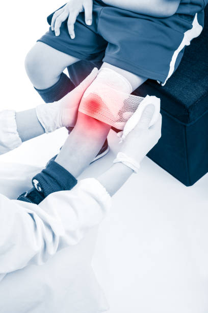 istock Doctor makes bandage on knee patient, on white background. 649362630