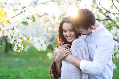 Young couple in love kissing and hugging in nature