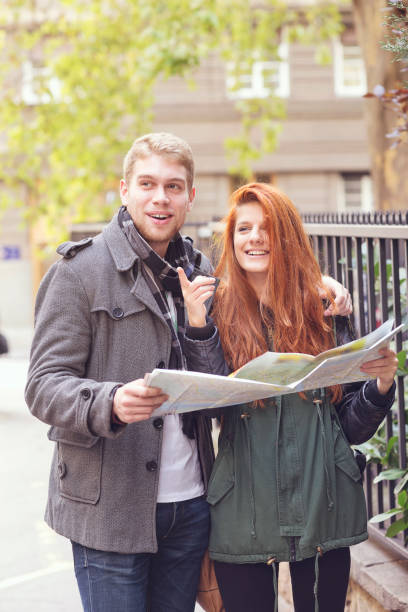 istock Happy tourist sightseeing city with map 649363936