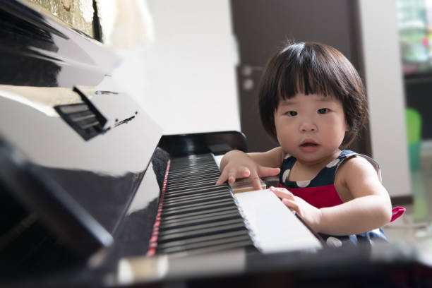 istock Little Asian child at piano 649366630
