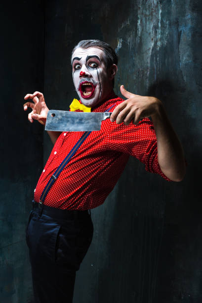 istock The crazy clown holding a knife on dack. Halloween concept 649369978