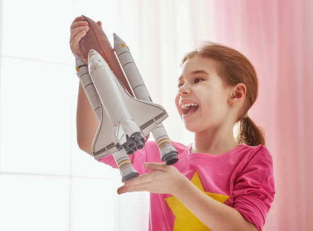 istock girl playing with toy rocket 649376604