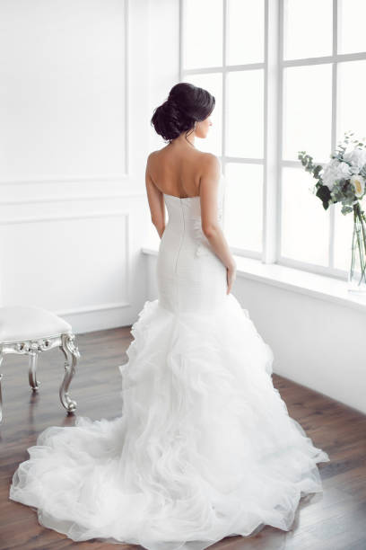 istock Beautiful bride in front of a window 649377524