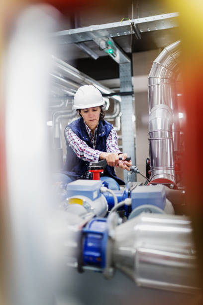 istock Woman working in the boiler room 649377616
