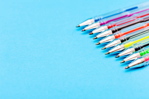 istock Multicolored ballpoint pens in diagonal row on blue 649383760