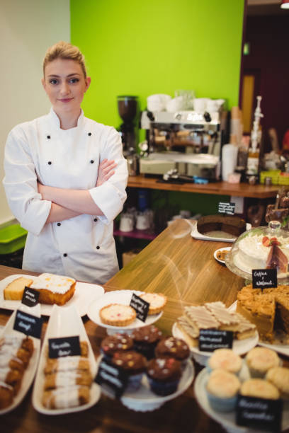 istock Portrait of worker standing at chocolate counter 649391700