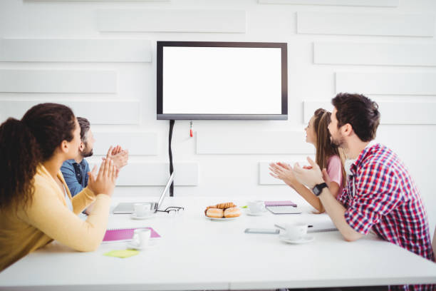 istock Happy colleagues applauding during meeting at creative office 649403202