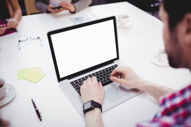 istock High angle view of executive using laptop in meeting room at creative office 649404032