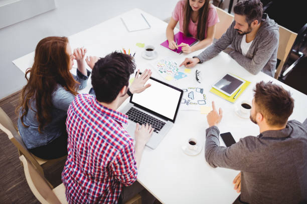 istock High angle view of partners discussing in meeting room at creative office 649405548
