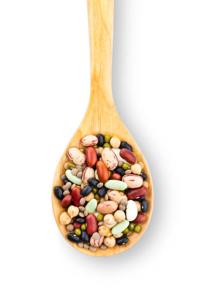 Wooden spoon filled with mixed beans Vertical shot of a wooden spoon filled with multicolored beans on white background. DSRL studio photo taken with Canon EOS 5D Mk II and Canon EF 100mm f/2.8L Macro IS USM adzuki bean photos stock pictures, royalty-free photos & images