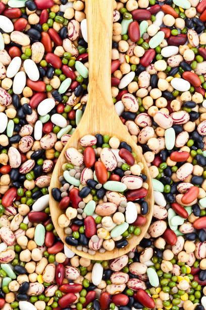 istock Wooden spoon filled with mixed beans 649409466