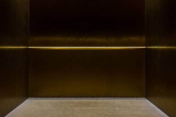 istock Empty Fancy Elevator Carriage Metal Pole Inside Metal Box Interior Closed Elegant Gold Bronze Overhead Floor Trap Blank Room 649420644